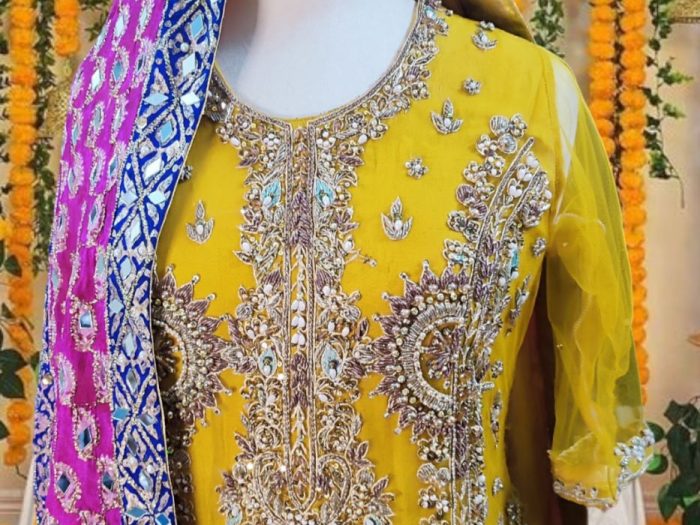 A close-up of Amber Splendor’s shirt, highlighting the exquisite hand embellishments and fine detailing that enhance its luxurious appeal.